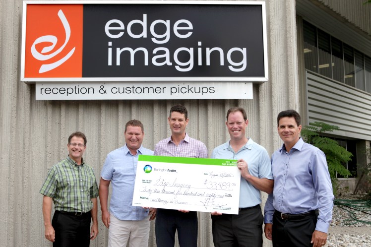 Burlington Hydro Inc. presenting Edge Imaging with an incentive cheque through the saveONenergy for Business Retrofit Program.