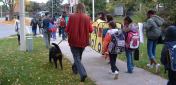 students and adults walking to school together
